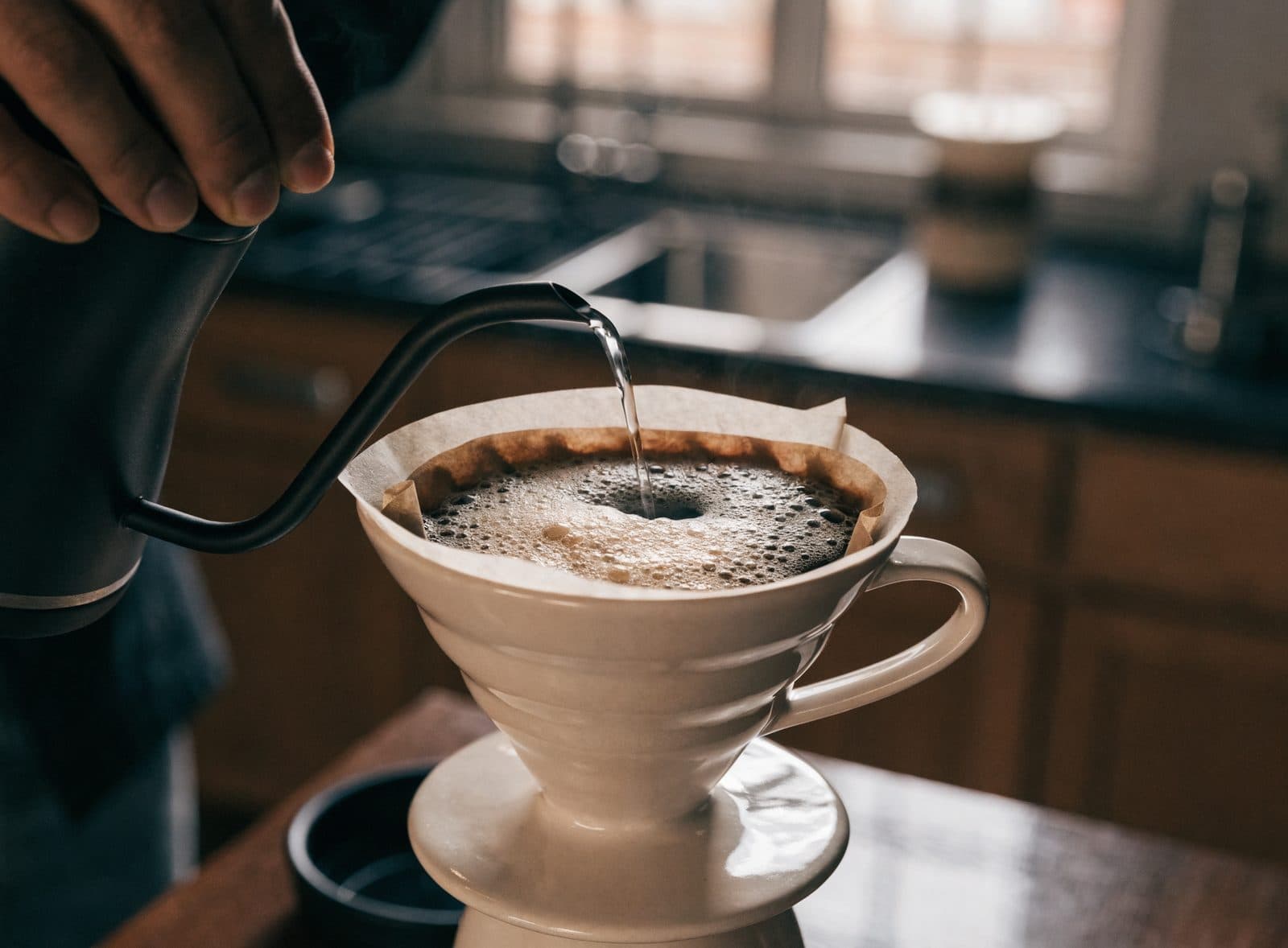 Pour-over bloom in an unbranded dripper, illustration — not a named farm.